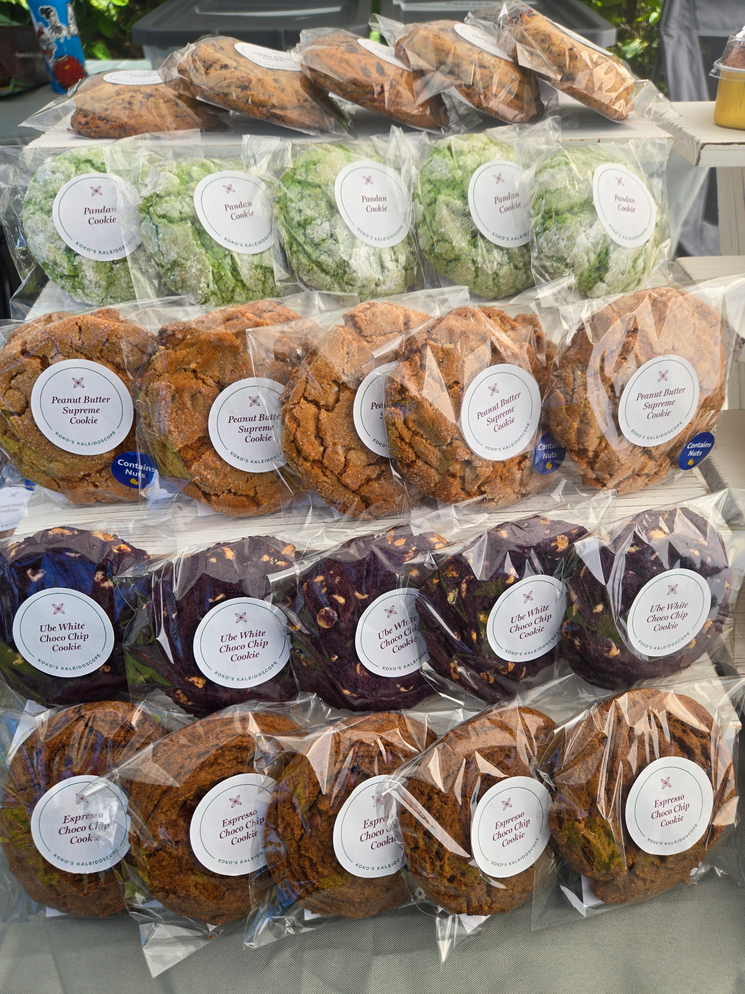 Rows of individually wrapped Koko's Kaleidoscope cookies including pandan, peanut butter supreme, ube white choco chip and espresso choco chip