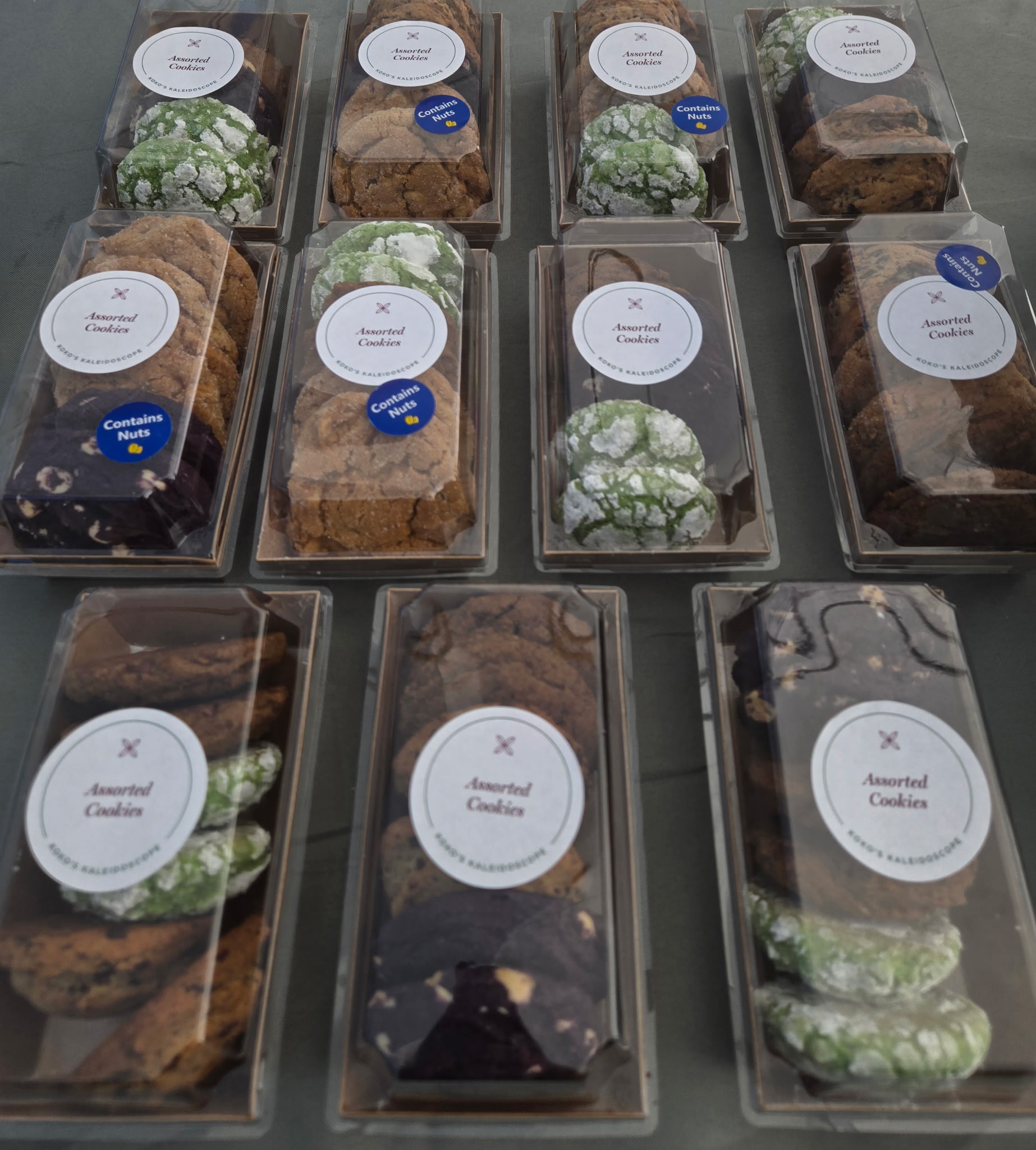 Assorted cookie boxes from Koko's Kaleidoscope containing pandan, ube and choco chunk cookies